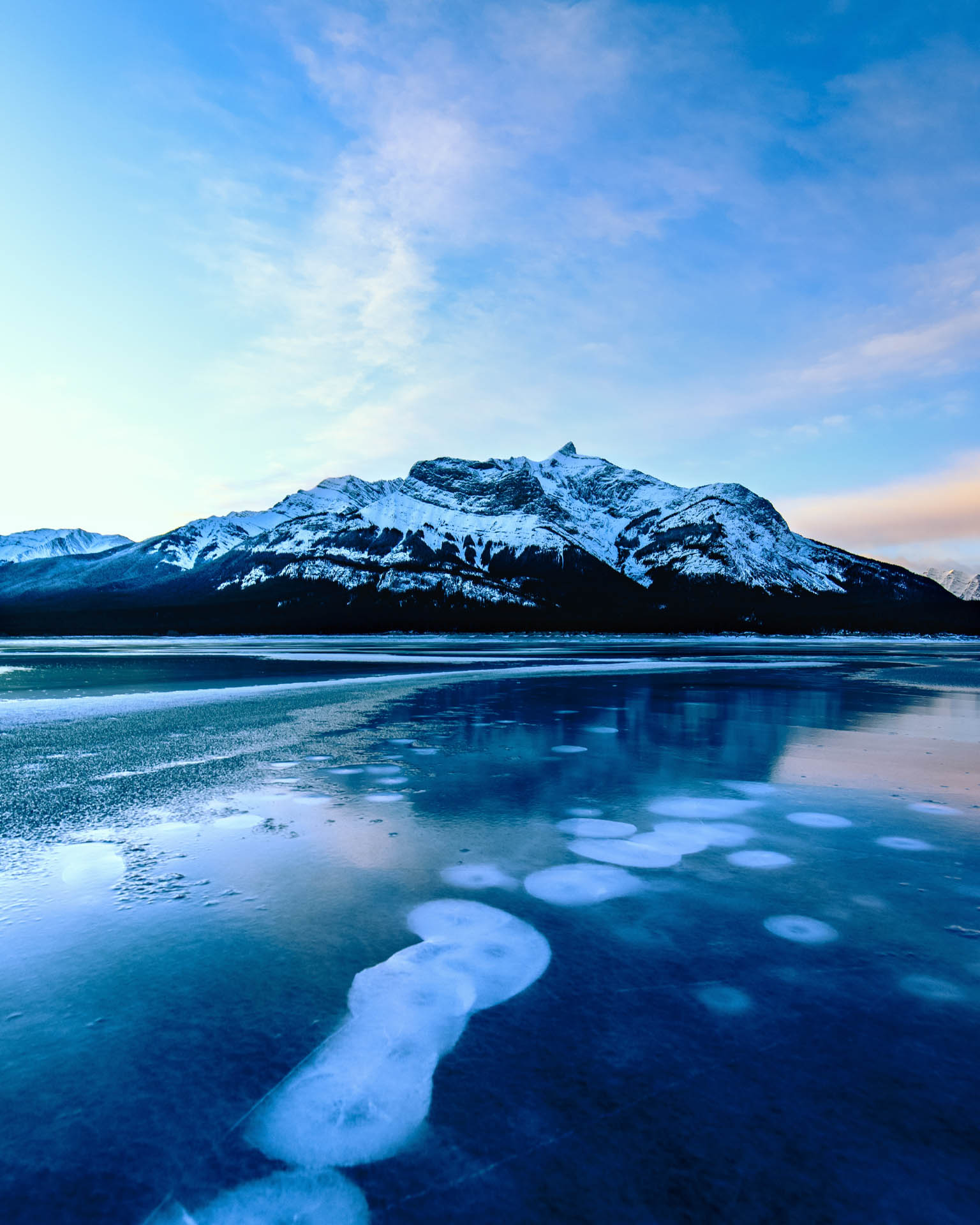 Ice bubbles trapped in the frozen surface of Abraham Lake, Alberta
